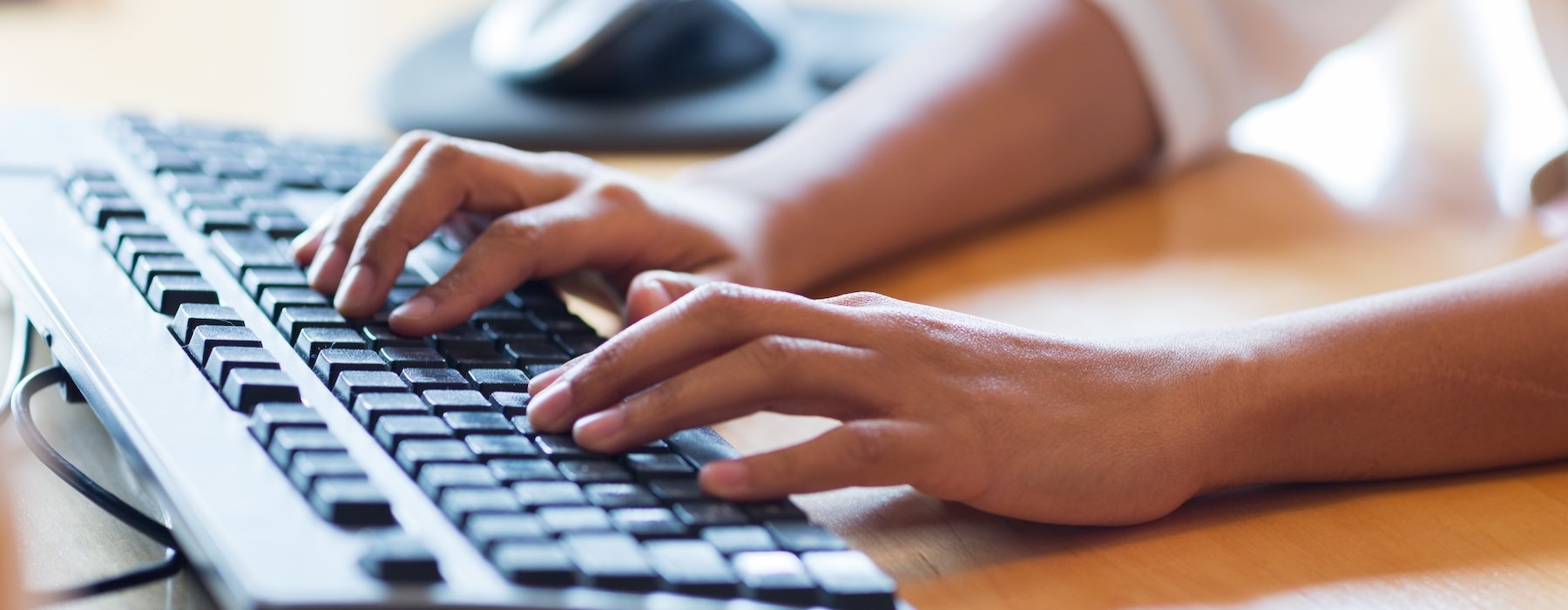 a close-up of hands on a keyboard