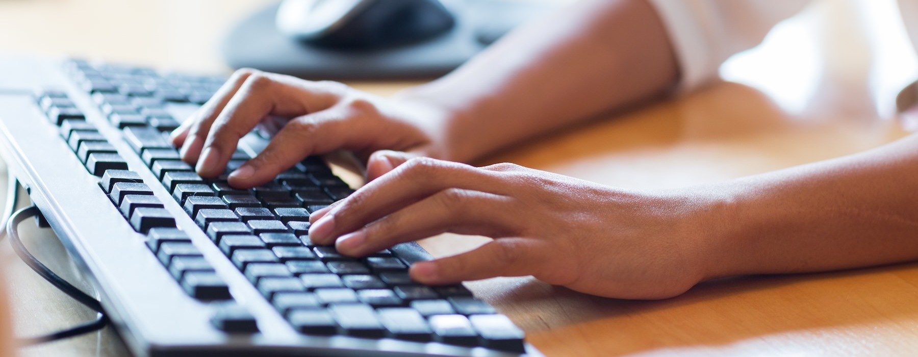 a close-up of hands on a keyboard